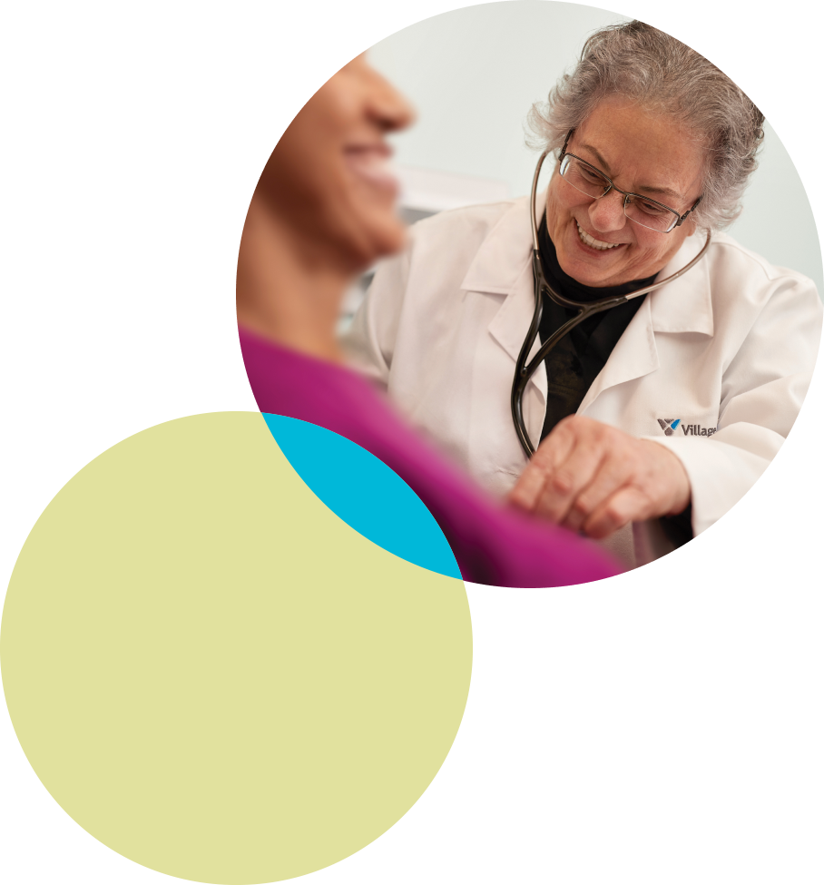 Village Medical healthcare professional with patient